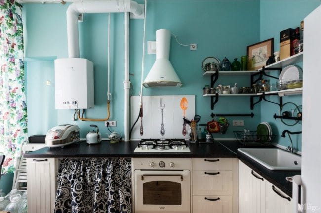 White water heater and white hood in the interior of a blue kitchen in a retro style