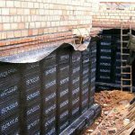 Photo of gluing waterproofing of the foundation with roll materials