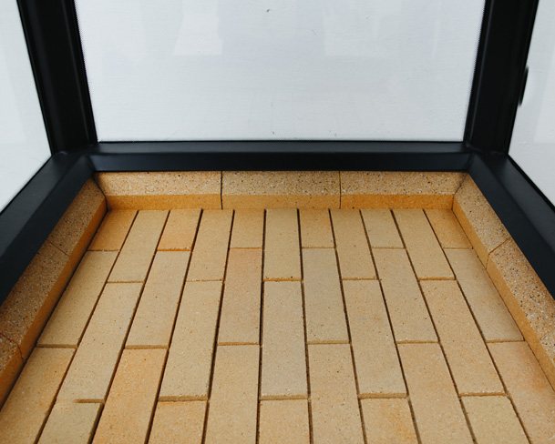 Under the fireplace insert, lined with fireclay bricks.